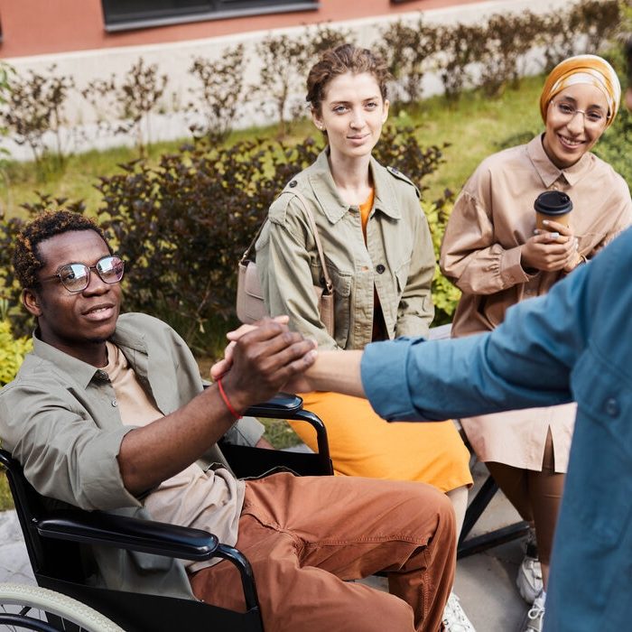 making-handshake-with-man-in-wheelchair-2023-11-27-05-05-43-utc