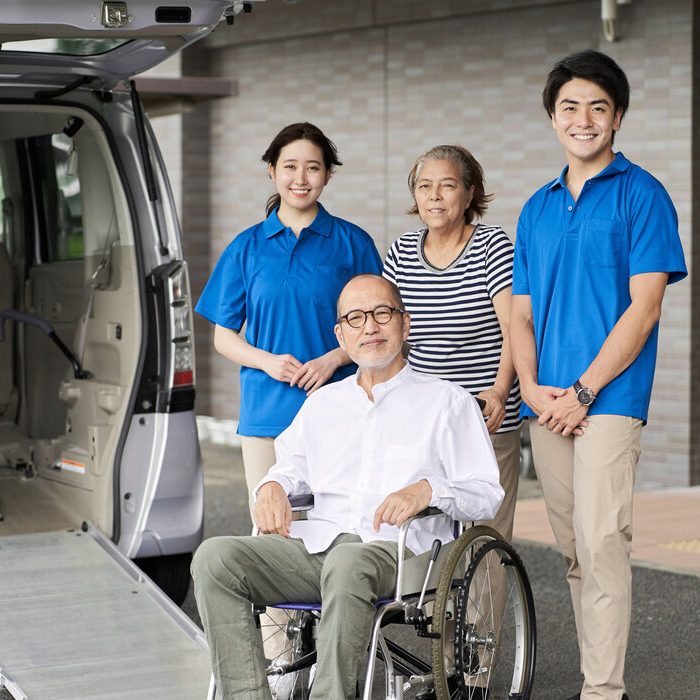 Wheelchair riding elderly and caregivers